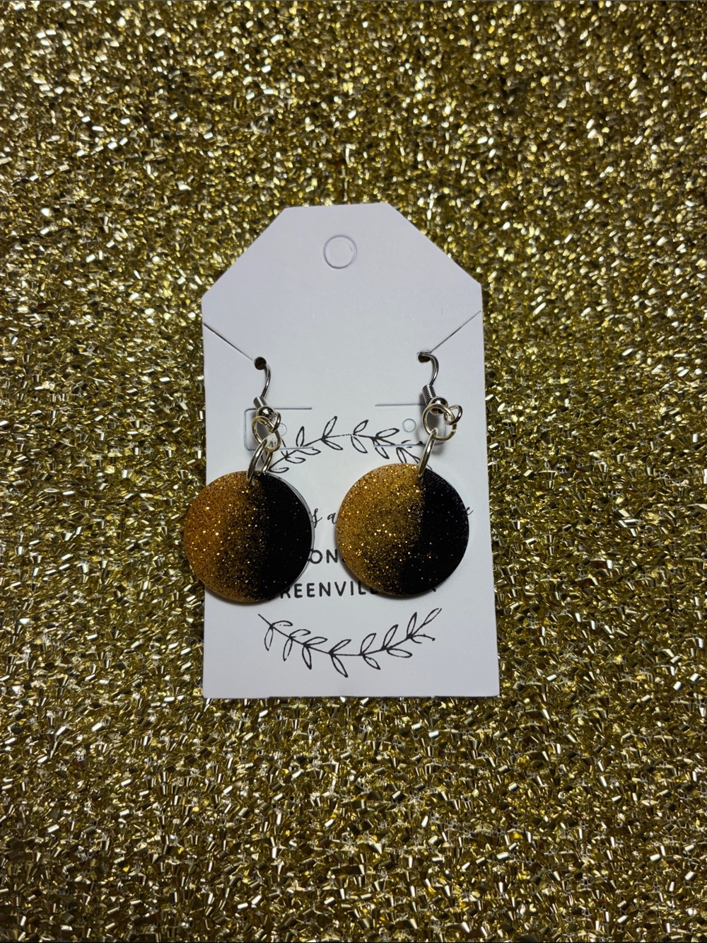 Gold and black circular earrings